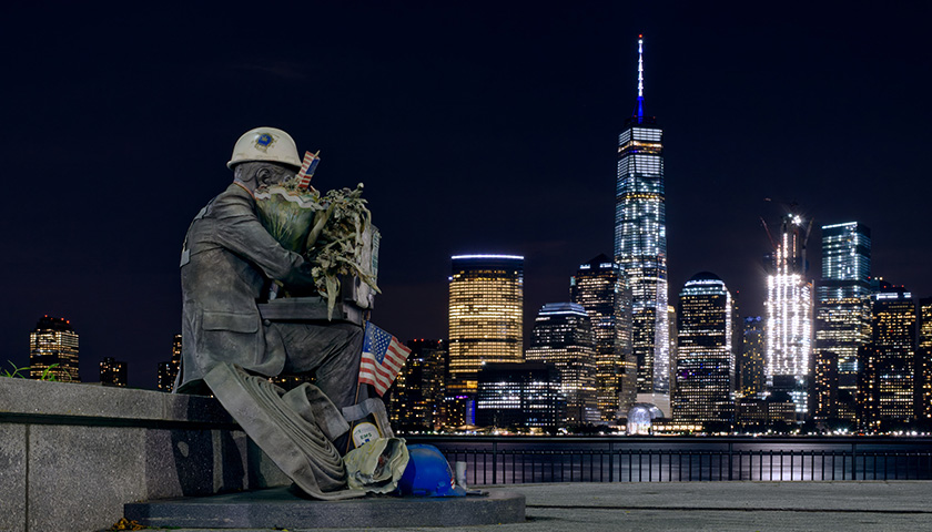 Across the water from NYC, with a first responder statue
