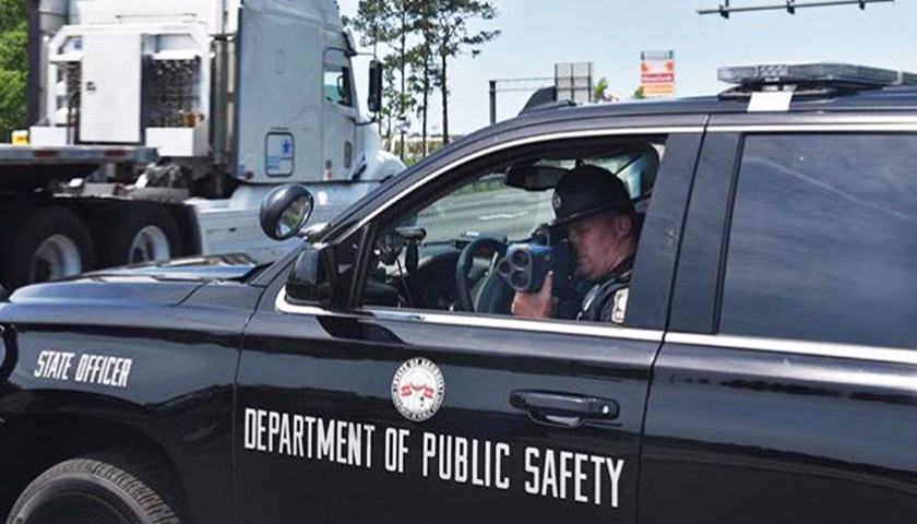 officer using radar gun in SUV to check Georgia residents' speed