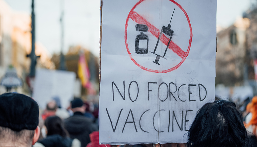 sign that says "NO FORCED VACCINE"