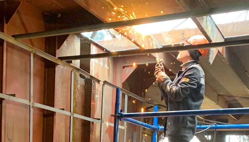 Man welding at steel beam